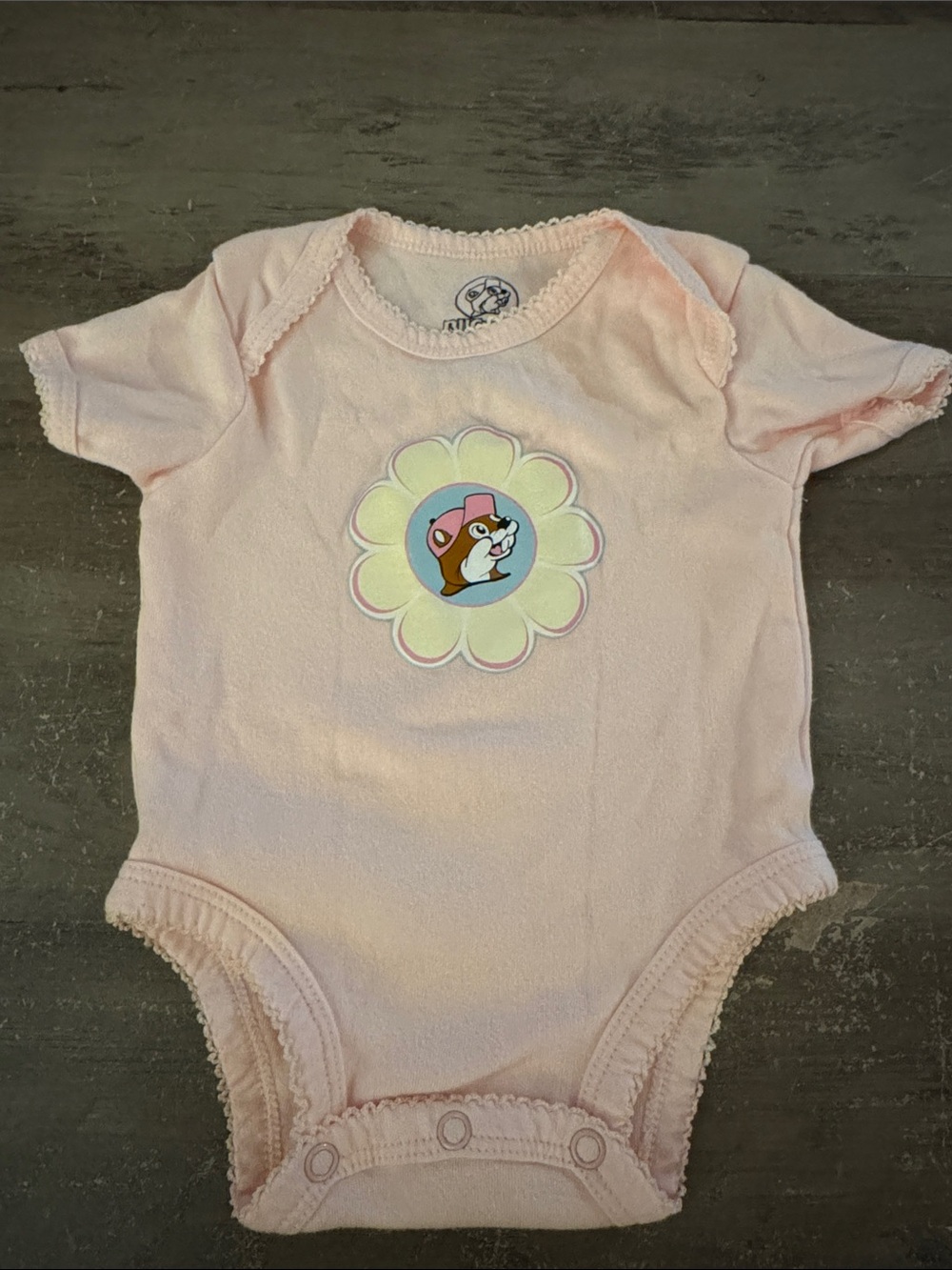 Buc-ee’s Light Pink Baby Bodysuit with Flower